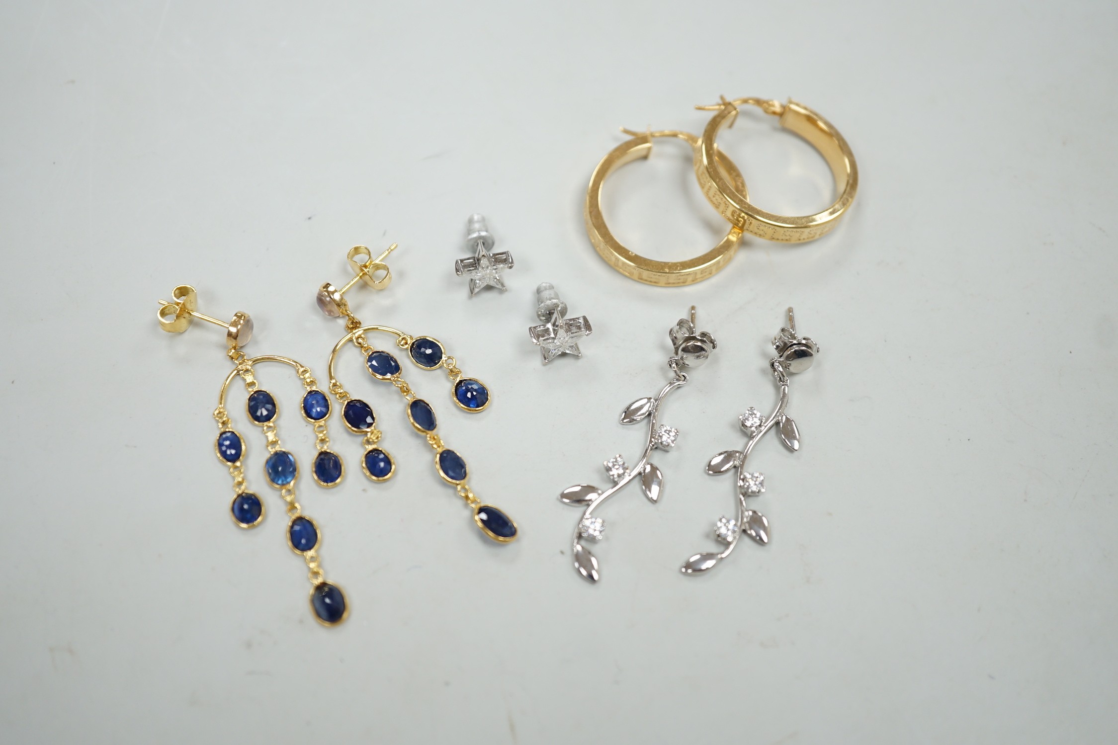 A modern pair of 18ct white gold and diamond cluster set star ear studs, 8mm, gross weight 1.1 grams, a similar pair of 14k, moonstone and sapphire cluster drop earrings, gross 3.5 grams and two pairs of 9ct earrings, gr